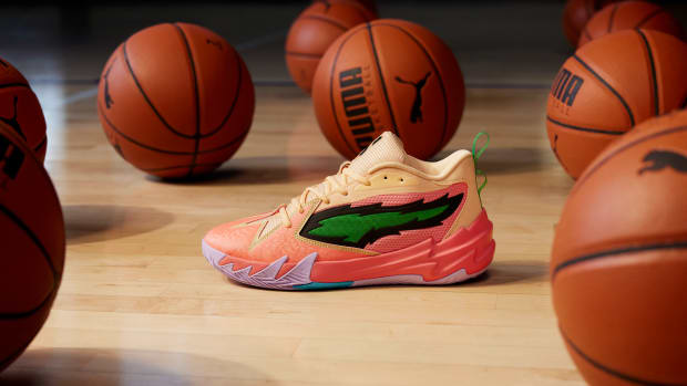 Side view of Scoot Henderson's peach and green PUMA sneakers.
