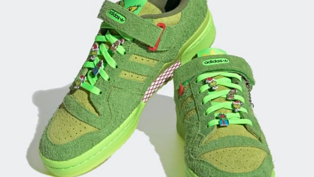 View of furry green Adidas shoes.
