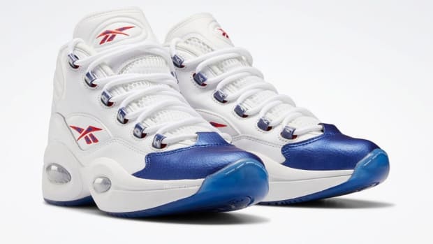 View of white and blue Reebok shoes.