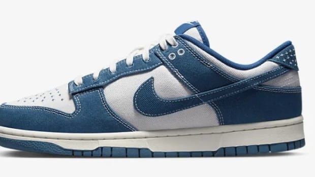 Side view of blue and white Nike Dunk sneaker.