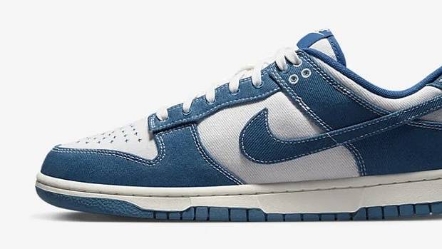 Side view of blue and white Nike Dunk sneaker.