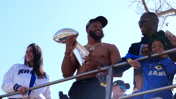 Feb 16, 2022; Los Angeles, CA, USA; Los Angeles Rams defensive end Aaron Donald holds the Vince Lombardi trophy during Super Bowl LVI championship parade. Mandatory Credit: Kirby Lee-USA TODAY Sports