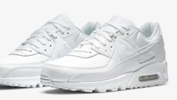 Side view of white Nike sneakers.