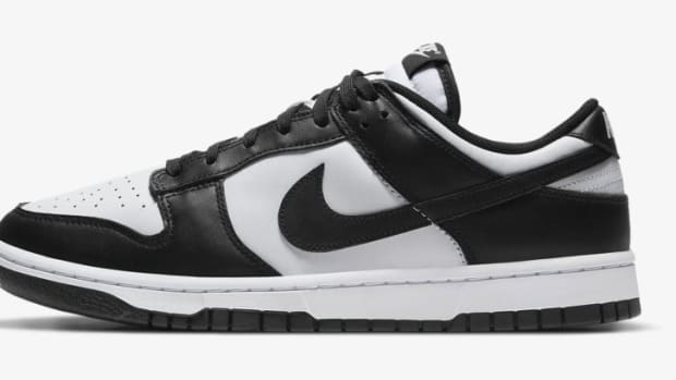 Side view of a black and white Nike Dunk sneaker.