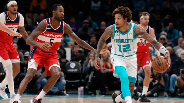 Charlotte Hornets guard Kelly Oubre Jr. (12) handles the ball guarded by Washington Wizards forward Will Barton (5) during the second half at Spectrum Center.