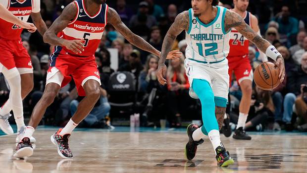 Charlotte Hornets guard Kelly Oubre Jr. (12) handles the ball guarded by Washington Wizards forward Will Barton (5) during the second half at Spectrum Center.