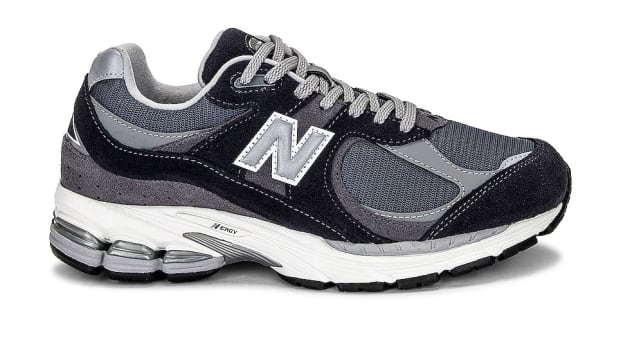 Side view of a grey and black New Balance sneaker.
