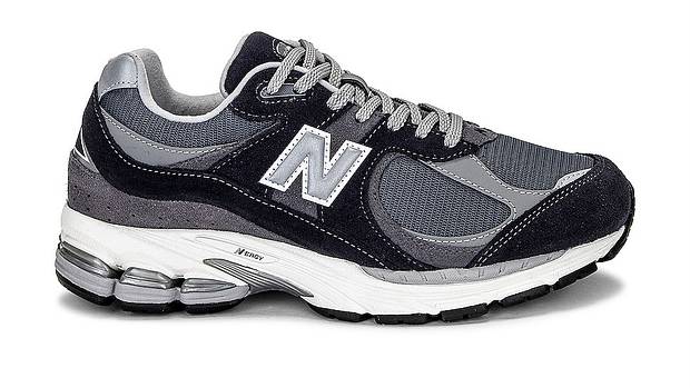 Side view of a grey and black New Balance sneaker.