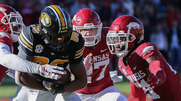 Missouri wide receiver Tauski Dove tries to shake free from Hayden Henry and Montaric Brown against Arkansas in a 2021 loss.