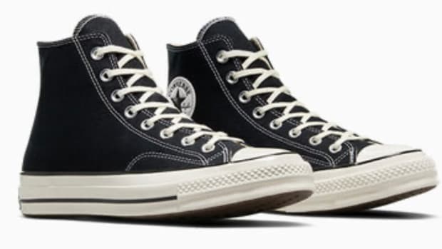 Side view of black and white Converse sneakers.