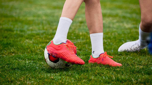 View of red Under Armour soccer cleats.