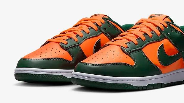 Side view of green and orange Nike Dunk shoes.