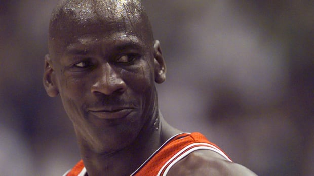 Michael Jordan smiles during a game.