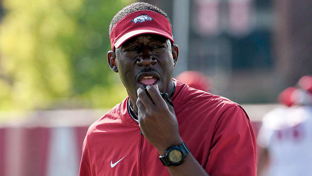 Razorbacks running backs coach Jimmy Smith during Friday morning's practice on the outdoor fields.