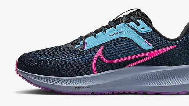 Side view of a black and pink Nike running shoe.