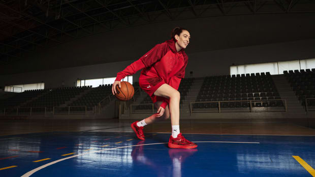 Breanna Stewart plays basketball in red Puma shoes.