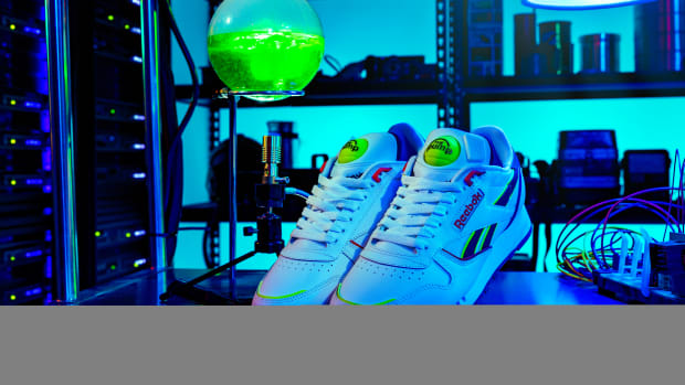 View of white and green Reebok shoes.