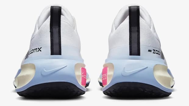 Rear view of white and blue Nike shoes.