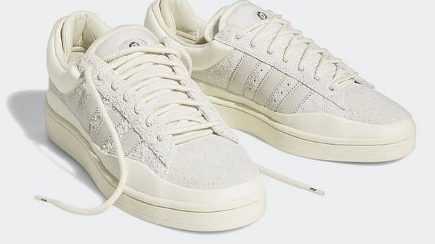 View of white adidas shoes.