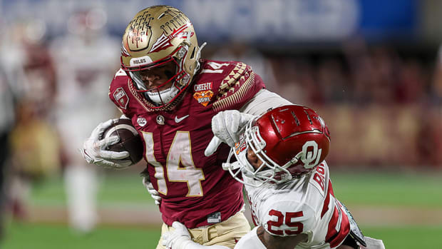 Florida State Seminoles wide receiver Johnny Wilson shoves Oklahoma Sooners defensive back Justin Broiles away after catching a pass in the fourth quarter during the 2022 Cheez-It Bowl.