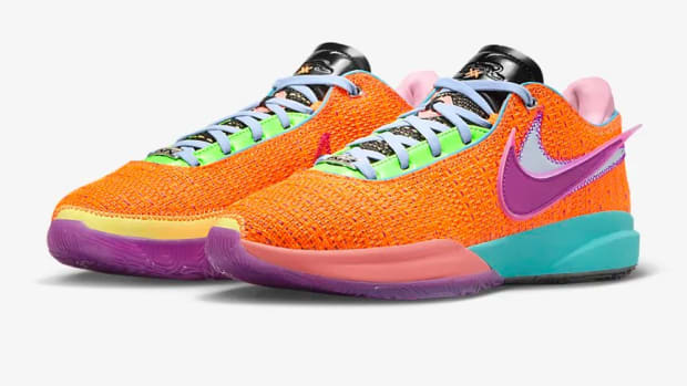 View of orange, purple, and pink Nike shoes.