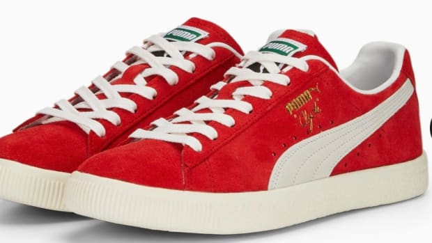 Side view of red and white Puma shoes.