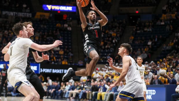 Jan 31, 2024; Morgantown, West Virginia, USA; Cincinnati Bearcats guard Day Day Thomas (1) drives down the lane and shoots during the first half against the West Virginia Mountaineers at WVU Coliseum. Mandatory Credit: Ben Queen-USA TODAY Sports
