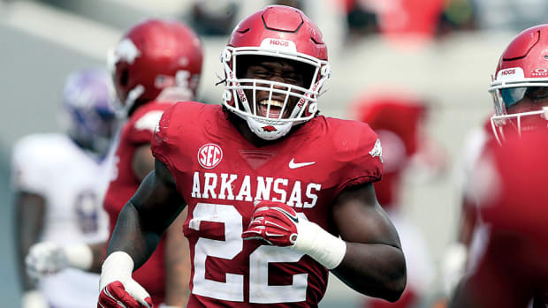 Razorbacks linebacker Brad Spence celebrates after returning an interception for a touchdown in the opener