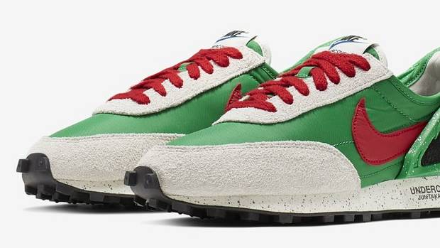 Side view of green, red, and black Nike sneakers.