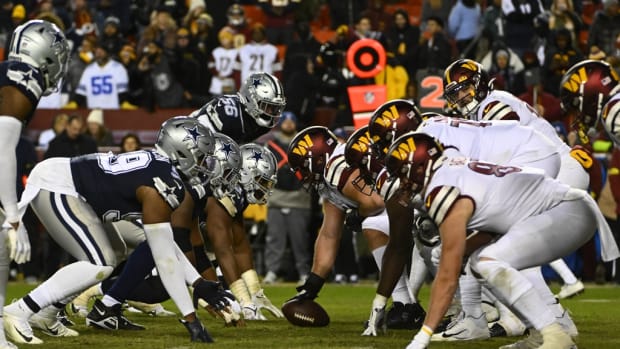 Washington Commanders and Dallas Cowboys at the line of scrimmage during the second half at FedExField.