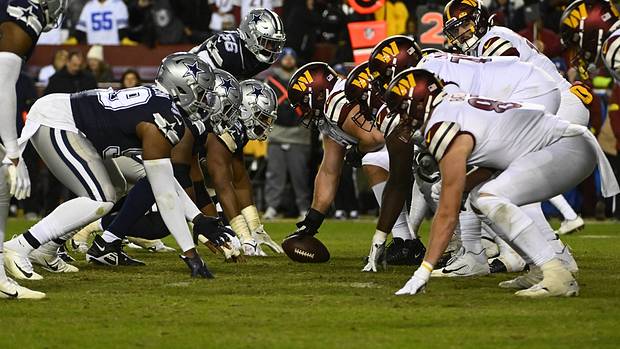 Washington Commanders and Dallas Cowboys at the line of scrimmage during the second half at FedExField.