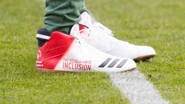 View of Aaron Rodgers' white and red Adidas cleats.