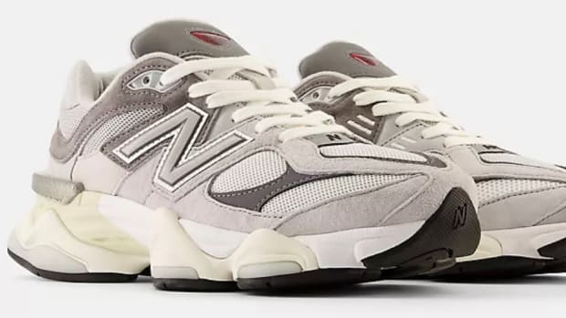 Side view of grey and white New Balance shoes.