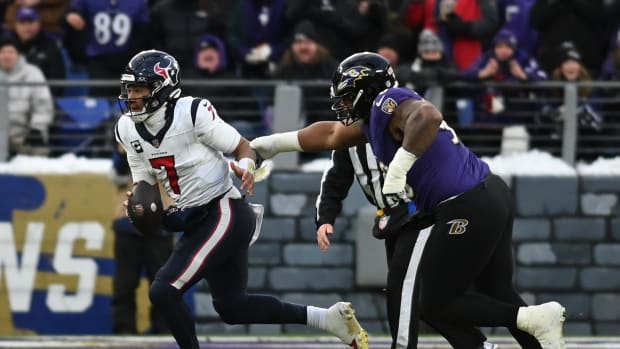 Texans quarterback C.J. Stroud runs the ball against Baltimore Ravens defensive tackle Justin Madubuike during the first quarter of a 2024 AFC divisional round game at M&T Bank Stadium.