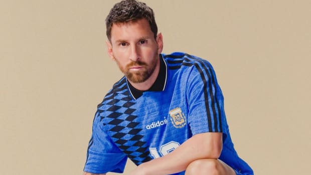 Leo Messi poses with a soccer ball in an adidas photo shoot.