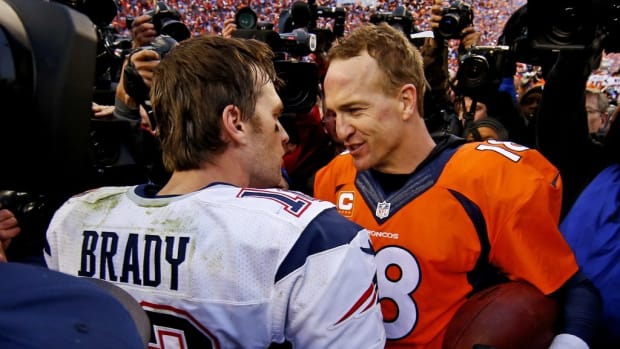 New England Patriots quarterback Tom Brady (12) and Denver Broncos quarterback Peyton Manning (18) shake hands after the game in the AFC Championship football game at Sports Authority Field at Mile High. Mandatory Credit: Kevin Jairaj-USA TODAY Sports