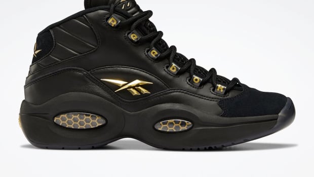 Black and gold Reebok shoes.