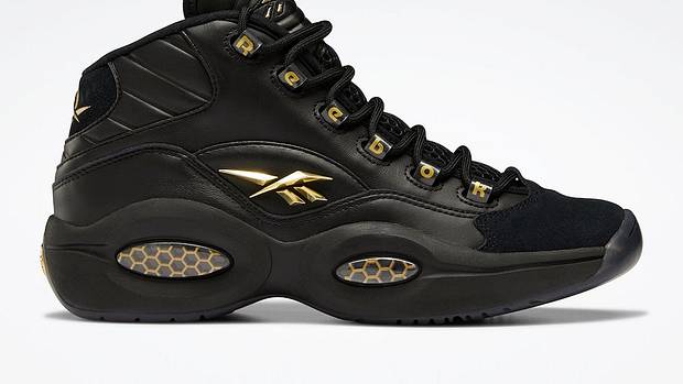 Black and gold Reebok shoes.