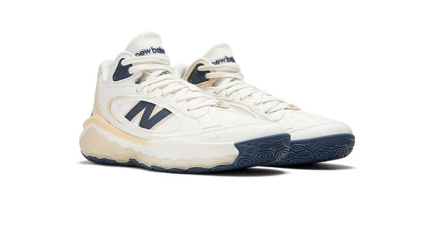 Side view of white and navy New Balance Fresh Foam basketball shoes.