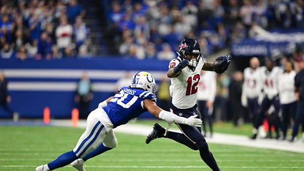 Texans' wide receiver Nico Collins runs against Indianapolis Colts safety Nick Cross (20) during the second quarter at Lucas Oil Stadium.
