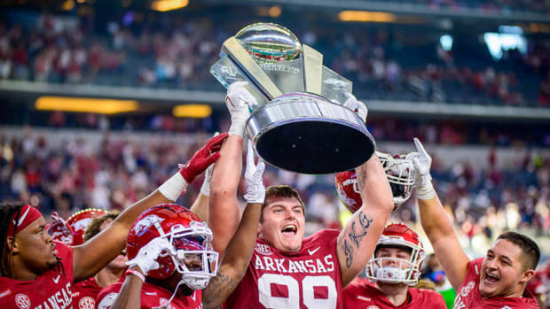 Former Arkansas defensive lineman John Ridgeway celebrates with the Southwest Classic Trophy after a win over Texas A&M in 2021.