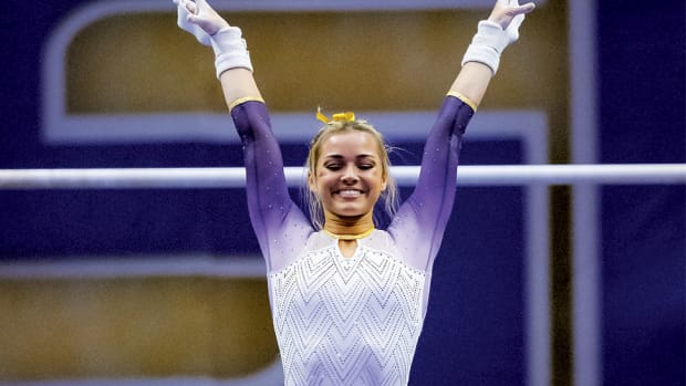 LSU Tigers senior Olivia "Livvy" Dunne performs a demonstration uneven bars routine against the Arkansas Razorbacks at Pete Maravich Assembly Center.