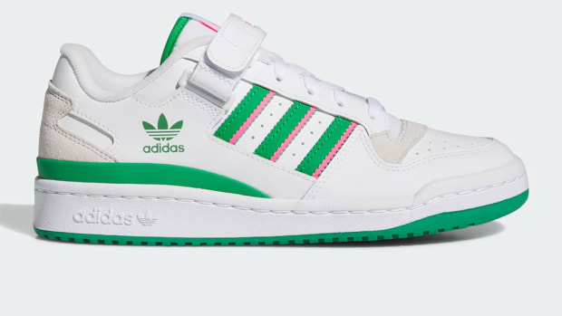 Side view of white, green, and pink adidas shoes.