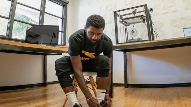 Kyrie Irving poses with ANTA sneakers.