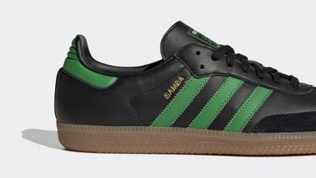 Side view of black and green adidas shoe.