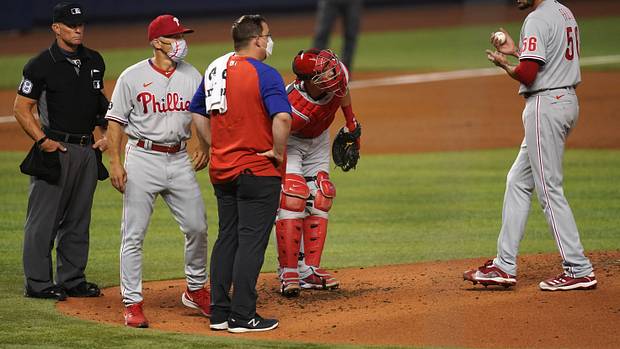 Zach Eflin is visited on the mound by medical trainer Paul Buchheit in Miami
