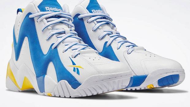 View of white, blue, and gold Reebok shoes.