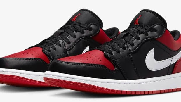 Side view of red and black Air Jordan sneakers.