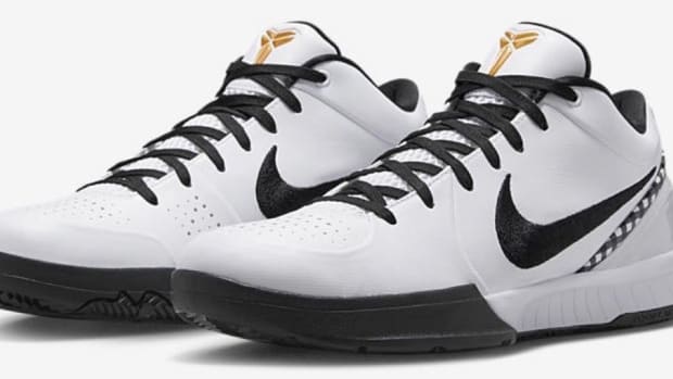 Side view of white and black Nike Kobe shoes.