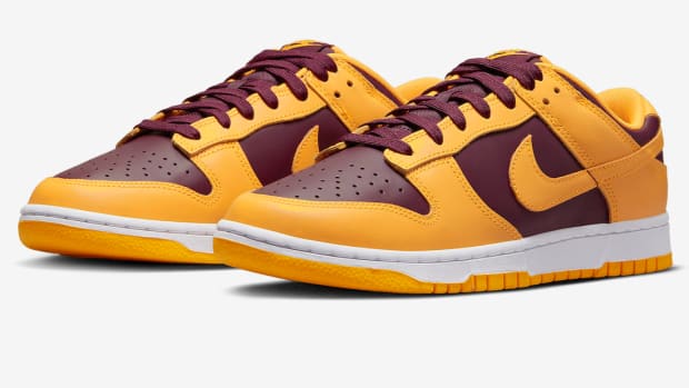 Maroon and gold Nike Dunk shoes.
